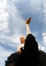 Ostrich on a farm carrying a young girl on his back