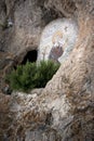 OSTROG, Montenegro: Cave and icon of Saint Venerable Isaiah Onogosha in rocky Serbian Orthodox Christian monastery Ostrog in mount Royalty Free Stock Photo