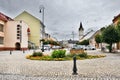Ostrov nad Ohri, Czech republic - September 09, 2017: historical paved Stare Namesti square with colorful flowers on foreground as