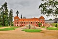 Ostrov nad Ohri, Czech republic - September 09, 2017: red historical building of Prince`s Palace with lagoon in chateau park at b