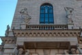 Ostrovsky Square 2a, Saint Petersburg, Russia, 11.10.2020. Ancient sculpture stands on balcony of facade in wall of building