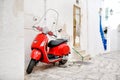 Ostuni, Apulia, Italy - red scooter in an alleyway Royalty Free Stock Photo