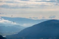 Oswaldiberg - A panoramic view on endless mountain chains in Austrian Alps. The mountains are shrouded in fog. A small village Royalty Free Stock Photo