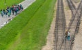 Oswiencim, Poland - September 21, 2019: Groups of Tourists walk along the train line where the wagons arrived with the