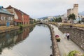 Otaru, historic canal and warehousedistrict in Hokkaido, Japan, with many tourists walking by Royalty Free Stock Photo