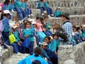 OTAVALO, ECUADOR - Feb 16, 2008: Quechua Indigenous Kids Sit in a Rock Arena