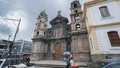 People walking in front of the El Jordan Church in the center of the city of Otavalo during a cloudy day