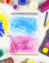 Notepad with an artistic brush on a white table. Tools for the artist. Flat lay. Copy space. Royalty Free Stock Photo