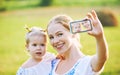 Other , baby daughter photographing selfie themselves by mobile phone in summer Royalty Free Stock Photo