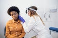 Otitis, hearing loss treatment concept. Young confident woman otorhinolaryngologist examining her african american