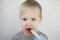 An otolaryngologist examines a child`s throat with a wooden spatula. A possible diagnosis is inflammation of the pharynx, tonsils Royalty Free Stock Photo