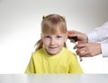 An otolaryngologist examines the ear of a child girl at the age of 5 years. Otoscopy, copy space for text Royalty Free Stock Photo