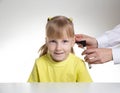 An otolaryngologist examines the ear of a child girl at the age of 5 years. Otoscopy, copy space for text