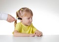 An otolaryngologist examines the ear of a child girl at the age of 5 years. Otoscopy, copy space for text