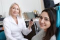 Otolaryngologist examining woman's ear with ENT telescope in hospital Royalty Free Stock Photo