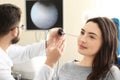 Otolaryngologist examining woman's ear with ENT telescope in hospital Royalty Free Stock Photo