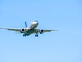 Aeroflot Sukhoi Superjet 100-95B flying against blue sky. Airplane arriving at Henry Coanda