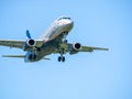 Aeroflot Sukhoi Superjet 100-95B flying against blue sky. Airplane arriving at Henry Coanda