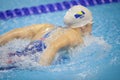 Details with a professional female athlete swimming in an olympic swimming pool