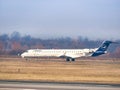 A Lufthansa Mitsubishi CRJ-900LR airplane on the airport runway at Henri Coanda International