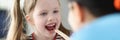 Otorhinolaryngologist doctor examining sore throat little girl in clinic Royalty Free Stock Photo