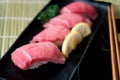 Otoro tuna sushi on black plate along with Japanese sauce and gr Royalty Free Stock Photo