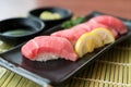Otoro tuna sushi on black plate along with Japanese sauce and gr Royalty Free Stock Photo