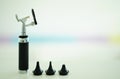 Otoscope for ear check for doctor ENT with 3 sizes of specula pieces on blur background with copy space