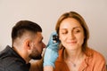 Otoscopy of ears with otoscope. ENT doctor. Consultation with otolaryngologist. Treatment of woman ear pain. Royalty Free Stock Photo