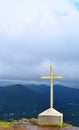 Ottakathalamedu - Holy Cross against background of clouds in sky and mountains Royalty Free Stock Photo