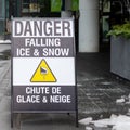 Street sign on the sidewalk warning of the danger of ice and snow falling from the above Royalty Free Stock Photo