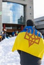 Rally with in support of Ukraine against war. Protest and march against Russian invasion. Man with Ukranian flag