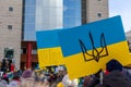 Rally with in support of Ukraine against war. Protest and march against Russian invasion. People with Ukranian flags in