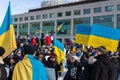 Rally in support of Ukraine against war. Protest and march against Russian invasion. Ukrainian flags