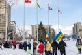 Rally with in support of Ukraine against war. Protest and march against Russian invasion. People with Ukrainian flags in