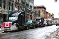 Rows of trucker convoy trucks on downtown street in Ottawa, Canada