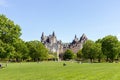 People in Majors Hill Park in spring. Fairmont Chateau Laurier Hotel building in city park in downtown Ottawa, Canada Royalty Free Stock Photo