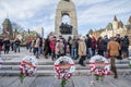 Crowd of Canadian war Veterans standing behind funeral wreath on National War memorial, on remembrance day