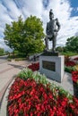 Ottawa, Canada - 09.04.2019: Vertical shot of John By, founder of Bytown, statue in Canadian capital. Red flowers around Royalty Free Stock Photo