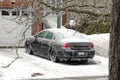 Ottawa, Ontario, Canada - April 5, 2023: A frozen car sits in a residential driveway covered in ice after an icestorm