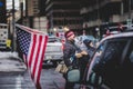 Man Standing with US Flag during the Convoy for Freedom 2022 Trucks and Tracors Protest