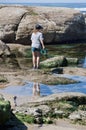 OTTER ROCK, OREGON/USA Ã¢â¬â May 11, 2019: Young girl exploring Tide Pools on Rocky Beach Royalty Free Stock Photo