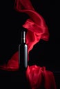 Ãâottle of red wine with flutters red cloth Royalty Free Stock Photo