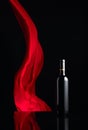 Ãâottle of red wine on a black reflective background Royalty Free Stock Photo