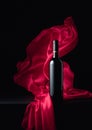 Ãâottle of red wine with flutters red cloth Royalty Free Stock Photo
