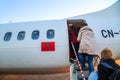 Ouarzazate, Morocco - Feb 28, 2016: passengers boarding airplane of Royal Air Morocco. People climbing ramp on background, rear vi