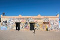Ouarzazate, Morocco - October 10, 2023: Wall painted with the faces of artists and different graffiti and a young boy Royalty Free Stock Photo