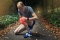 Ouch, that really hurts. a runner experiencing pain from an injured knee while out for a jog. Royalty Free Stock Photo