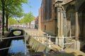 The Oude Delft canal with the external facade of Oude Kerk on the right side, Delft Royalty Free Stock Photo