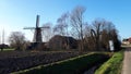 Oude molen a small town in the countryside in the Netherlands where there is a traditional old-fashioned wooden mill. Royalty Free Stock Photo